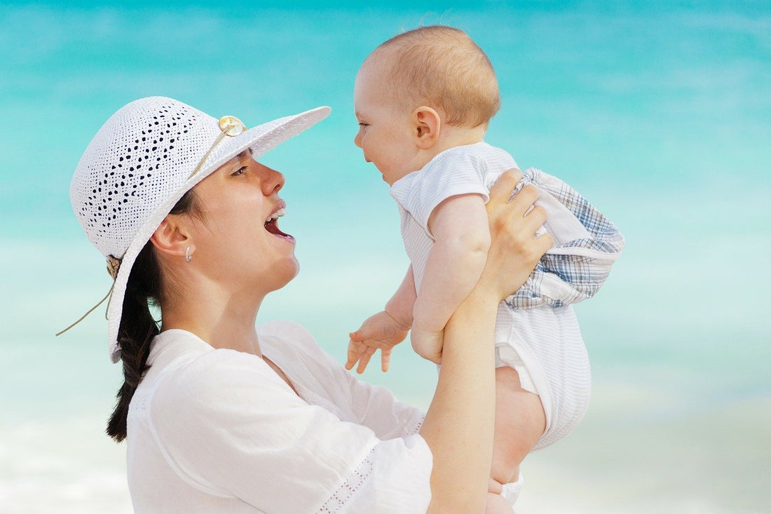 a mother holding a baby wearing a cute baby onesie