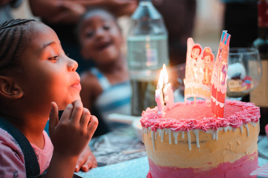 A girl blowing birthday candles