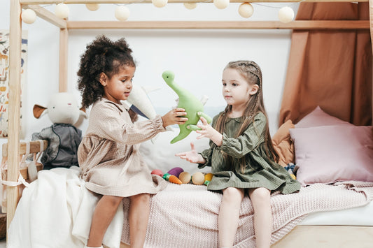 two toddler girls playing