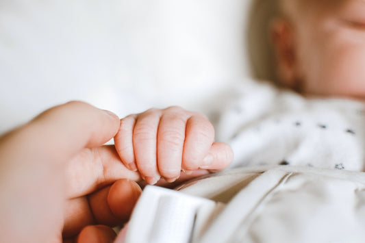 person holding a baby's hand