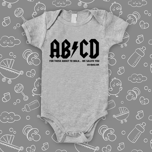 The rock n roll onesies with saying "ABCD" in grey