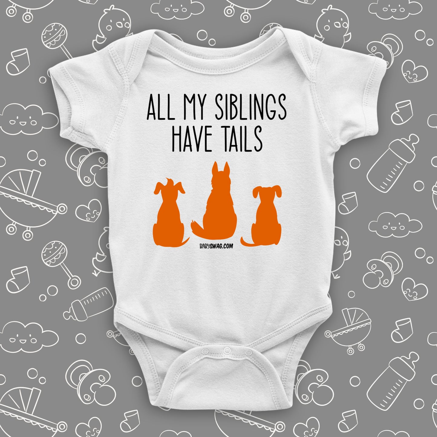 White cute baby onesie with "All My Siblings Have Tails"  saying and an image of three dogs. 