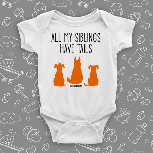 White cute baby onesie with "All My Siblings Have Tails"  saying and an image of three dogs.