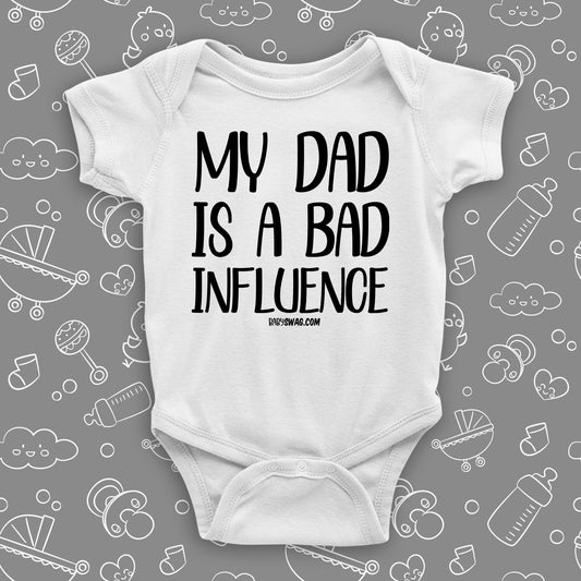 The ''My Dad Is A Bad Influence'' hilarious baby onesies in white.