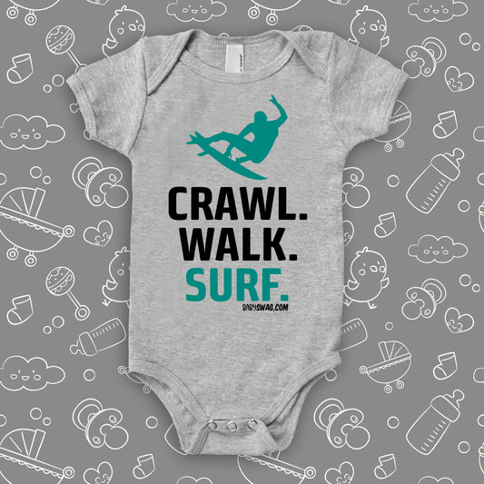 Unique baby boy onesies with saying: "Crawl. Walk. Surf" in grey.
