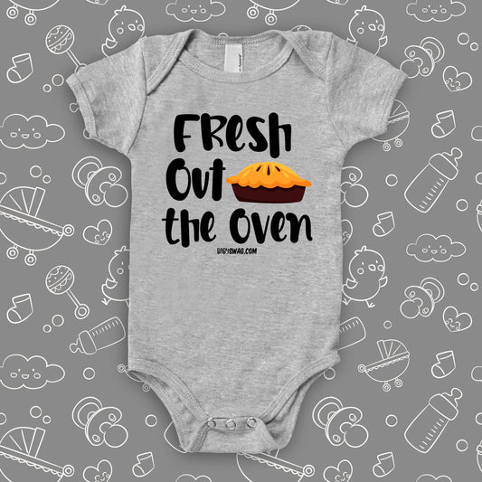 Cute baby onesies with saying "Fresh Out The Oven" in grey.
