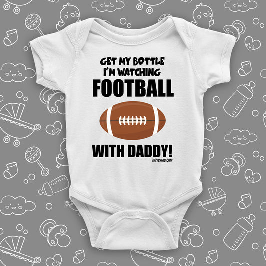 Cute baby boy onesies with saying "Get My Bottle I'm Watching Football With Daddy" in white. 