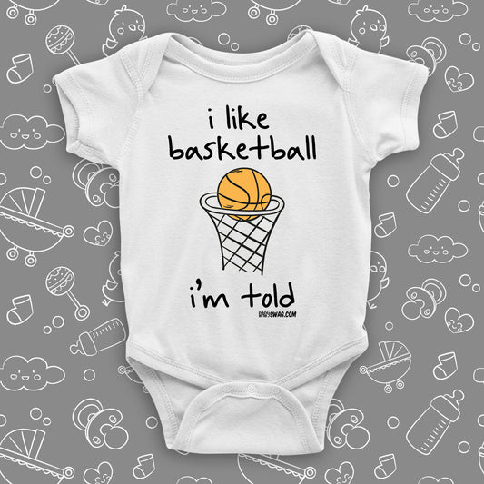 Cute baby boy onesies with saying "I Like Basketball, I'm Told" in white.
