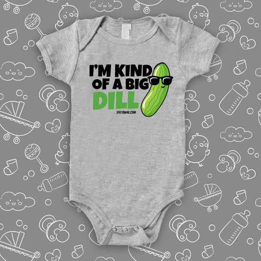 A cute baby onesie saying "I'm Kind Of A Big Dill", with the image of a pickle wearing sunglasses, in grey.