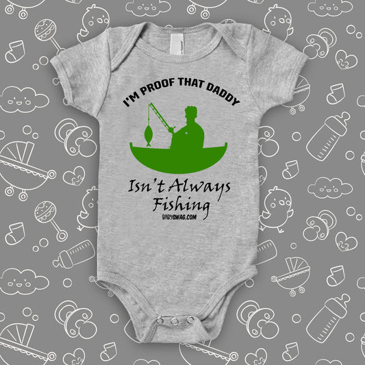 Hilarious baby onesies with a saying "I'm Proof That Daddy Isn't Always Fishing" in grey and the drawing of a man in a fishing boat included.