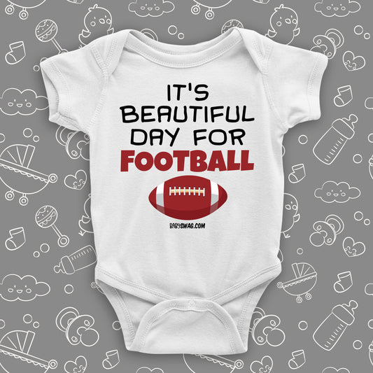 White baby boy onesie saying "It's a beautiful day for football" and a print of a ball.