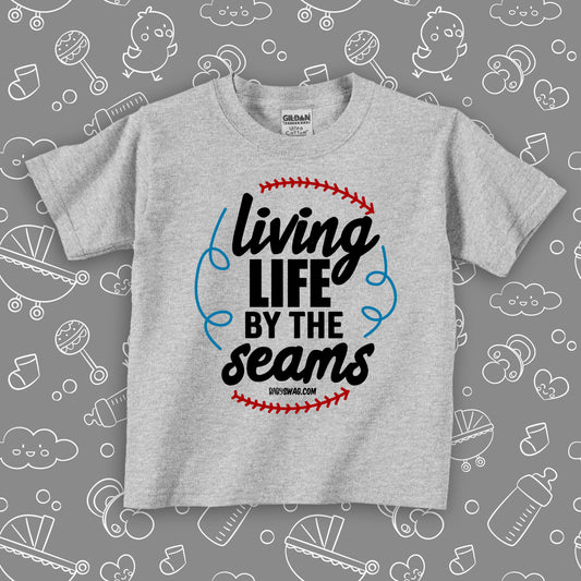 Toddler boy graphic tees with saying "Living Life By The Seams" in grey.