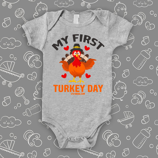 Cute baby onesies with saying "My First Turkey Day" and an image of a turkey in grey.