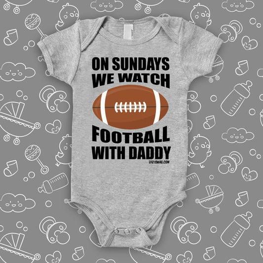 Cute baby boy onesies with saying: "On Sunday We Watch Foodball With Daddy" in grey.