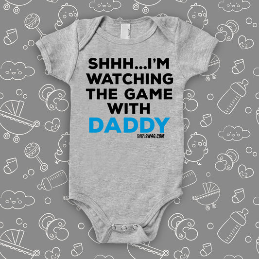 Cool toddler cllothes with saying "Shh...I'm Watching The Game With Dad" in grey.