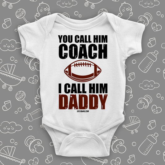 Cute baby onesie with saying "You Call Him Coach, I Call Him Daddy" in white.