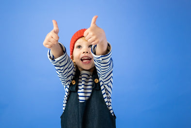 a kid showing thumbs up