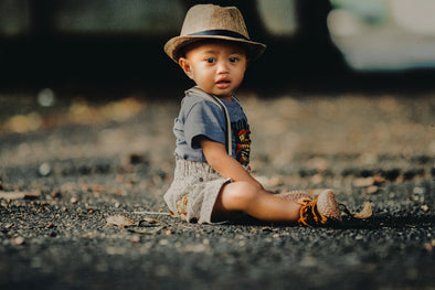 a toddler boy wearing a hat