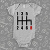 The "6 Gearshirt Race Car" graphich baby onesies in grey. 