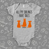 Grey cute baby onesie with "All My Siblings Have Tails"  saying and an image of three dogs.
