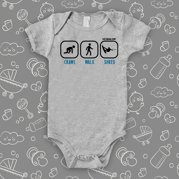 Cute baby boy onesies with saying "Crawl. Walk, Shred" in grey.