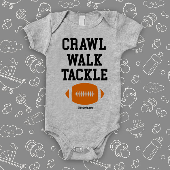 The "Crawl. Walk. Tackle" cute baby onesies in grey. 