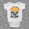 White taco baby onesie with "Every now and then I fall apart" print and an image of a tasty taco.