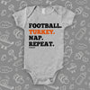 Cool baby onesies with saying "Football. Turkey. Nap. Repeat" in grey. 