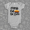 Cute baby onesies with saying "Fresh Out The Oven" in grey. 