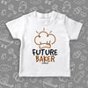 White toddler shirt with "Future baker" print and a drawing of baker's hat. 