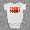 Funny baby onesies with saying "Gobble, gobble" in white.