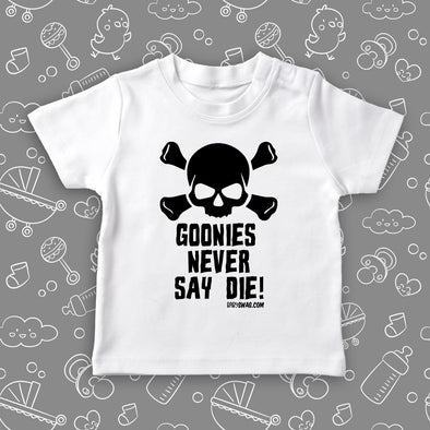 White cool toddler shirt with an image of a skull and a "Goonies Never Say Die" print.