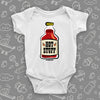 White cute baby onesie with a bottle of red sauce labeled "Hot stuff". 