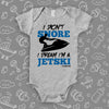 The ''I Don't Snore, I Dream I'm A Jetski'' funny baby onesies in grey.