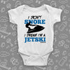 The ''I Don't Snore, I Dream I'm A Jetski'' funny baby onesies in white. 