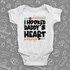 Unique baby onesies with saying "I Hooked Daddy's Heart" in white.