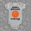 Unique baby onesies with saying "Adding A New Player To The Team" in white. 