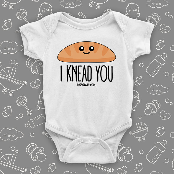 Funny infant onesie saying "I knead you", color white.