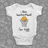 Cute baby boy onesies with saying "I Like Basketball, I'm Told" in white.
