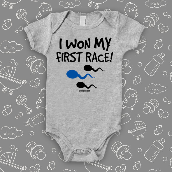 Funny baby onesies with saying "I Won My First Race" in grey. 
