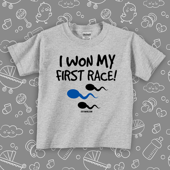 Cool toddler shirt saying "I Won My First Race!", in color gery.