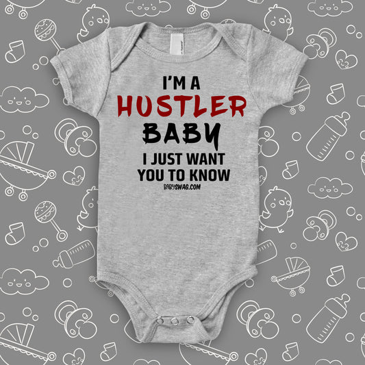 Funny baby onesies with saying "I'm A Hustler Baby" in gery.
