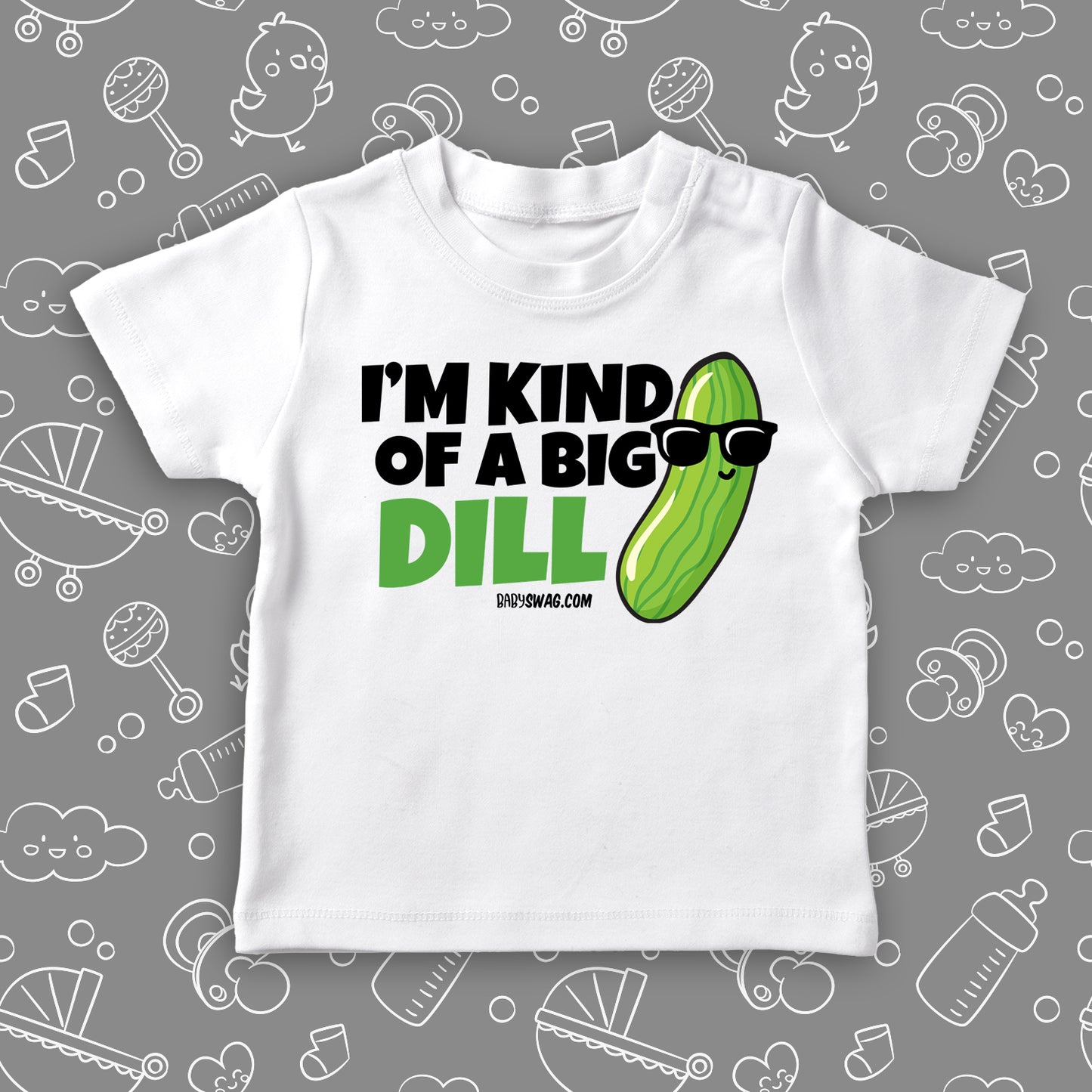 A funny toddler shirt saying "I'm Kind Of A Big Dill", with the image of a pickle wearing sunglasses, in white. 
