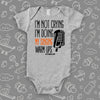 Hilarious baby onesies with saying "I'm Not Crying, I'm Doing My Singing Warm Ups" in grey.   