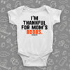 Hilarious baby onesie with saying "I'm Thankful For Mom's Boobs" in white. 