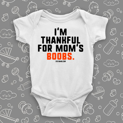 Hilarious baby onesie with saying "I'm Thankful For Mom's Boobs" in white. 