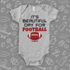 Grey baby boy onesie saying "It's a beautiful day for football" and a print of a ball