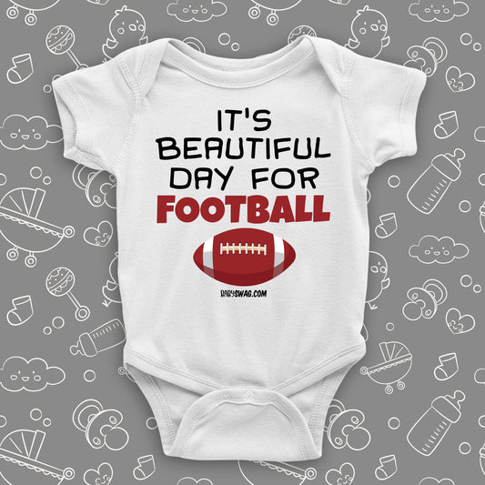 White baby boy onesie saying "It's a beautiful day for football" and a print of a ball.