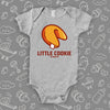 A grey cute baby onesie with "Little Cookie" print and an image of a fortune cookie. 