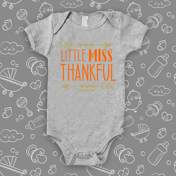 Cute baby girl onesies with saying "Little Miss Thankful" in grey.
